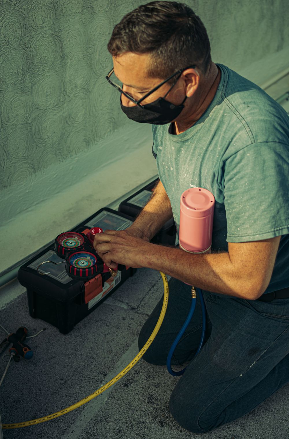 HVAC technician servicing an AC unit