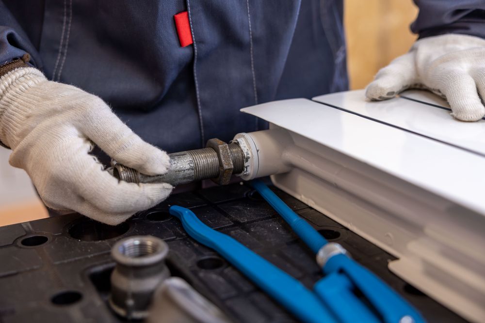 Close up of a plumber working on copper pipes